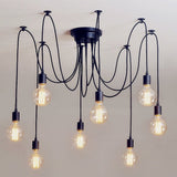 Black spider chandelier with eight cables and bare bulbs on a white ceiling