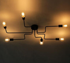 Black sputnik chandelier lit warmly with bulbs at different heights
