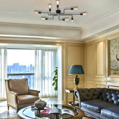Black sputnik chandelier lit on a ceiling in a classic panelled lounge