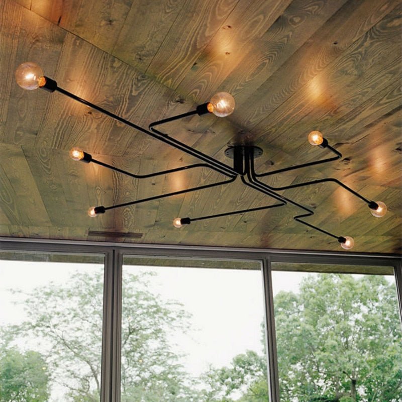 Black sputnik chandelier fixed to a timber clad ceiling by a window
