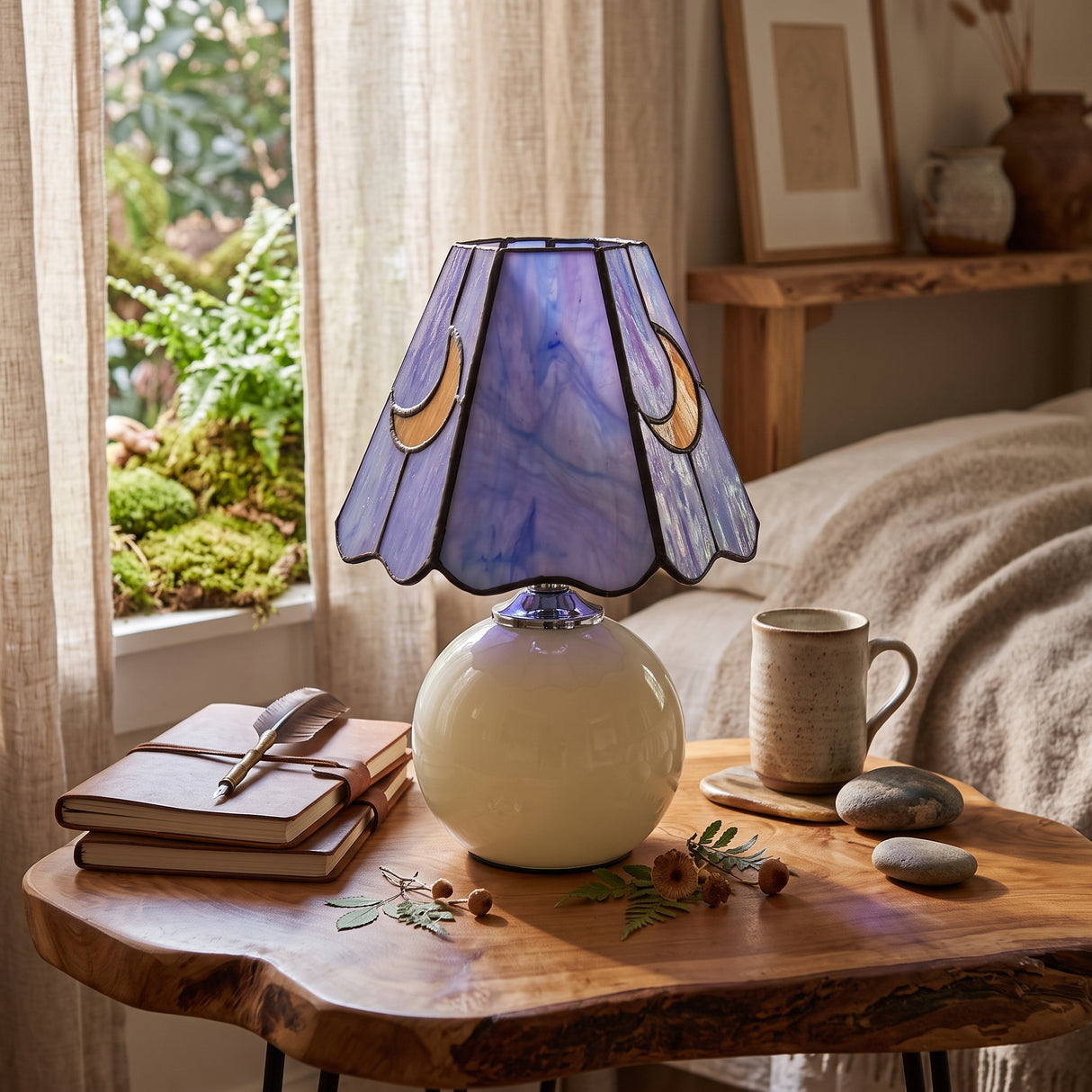 Stained glass table lamp with lilac moon shade on a live edge timber table
