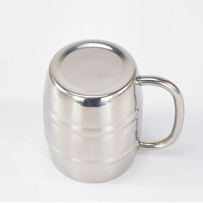 Stainless steel insulated beer mug filled with cold lager outdoors