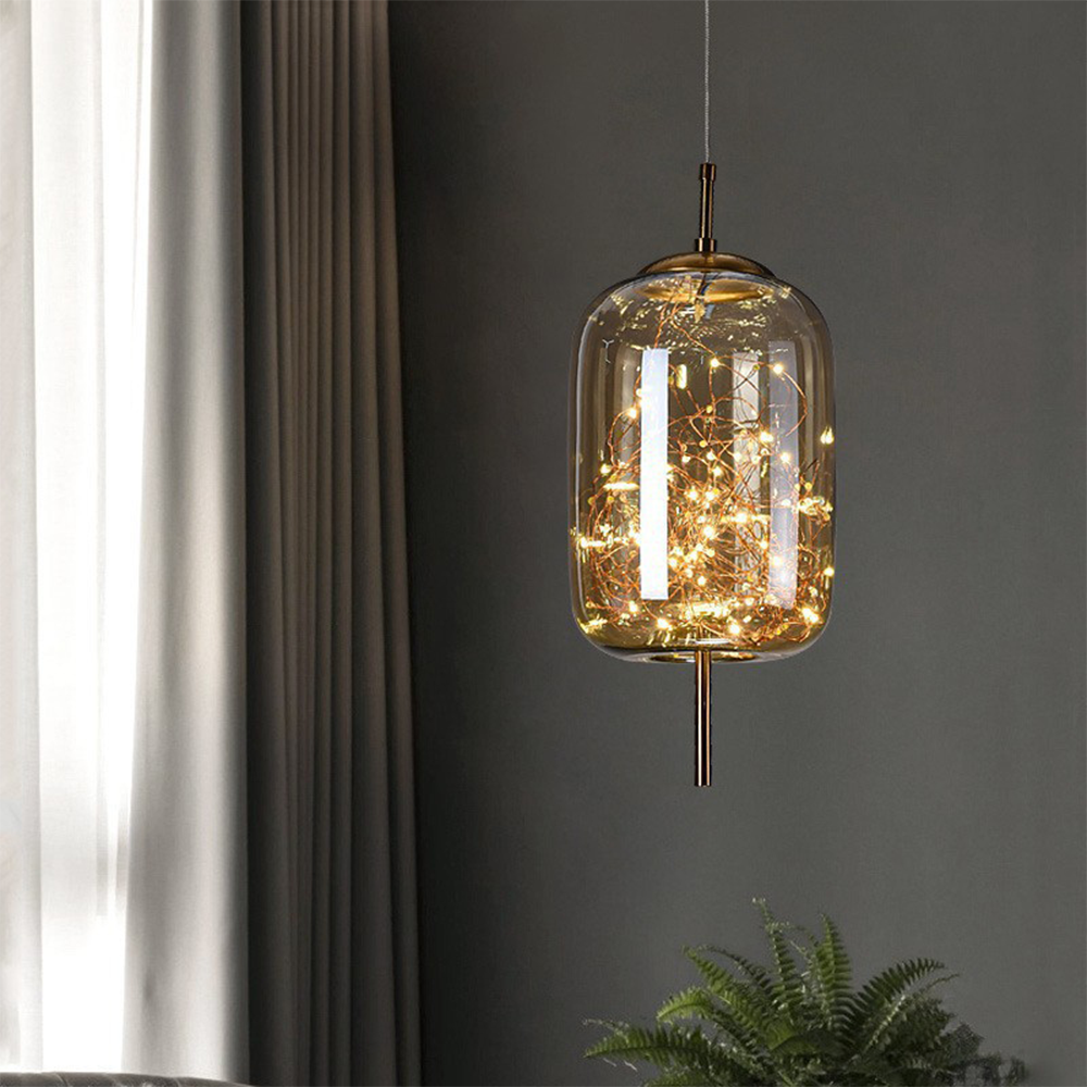 Amber glass capsule pendant filled with a cluster of tiny warm LEDs