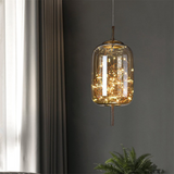 Amber glass capsule pendant filled with a cluster of tiny warm LEDs