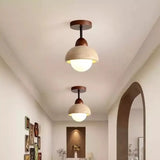 Stone ceiling light with opal glass globe glowing warm
