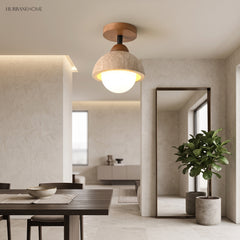 Stone dome ceiling light glowing over an open plan dining and living space