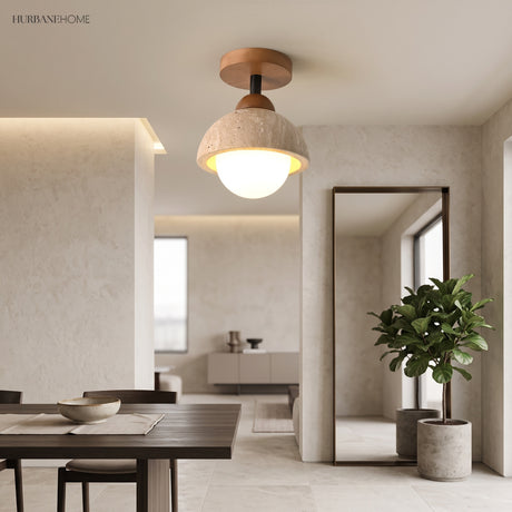 Stone dome ceiling light glowing over an open plan dining and living space