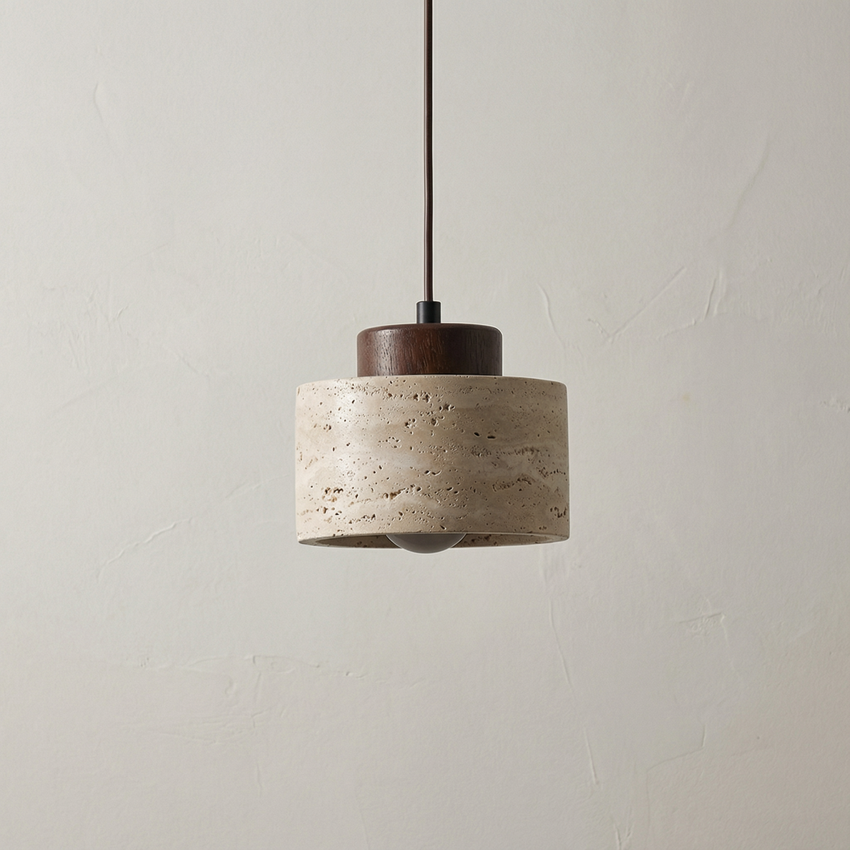 Short stone pendant with a dark walnut cap on a pale ground