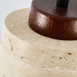 Close view of the dark wood cap seated on the pitted stone shade
