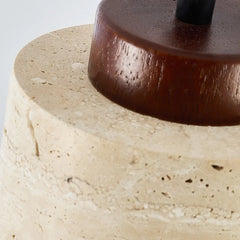 Close view of the dark wood cap seated on the pitted stone shade