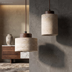 Stone pendants with dark wood caps lit against a grey wall