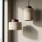 Stone pendants casting soft shadows across a plaster wall