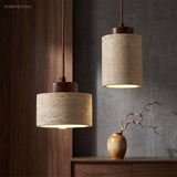 Stone pendants with walnut caps above a dark wood sideboard