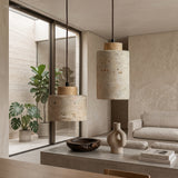 Stone pendants with wood caps lit beside a plant filled window