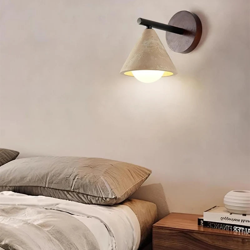Stone wall light with frosted glass globe glowing warm
