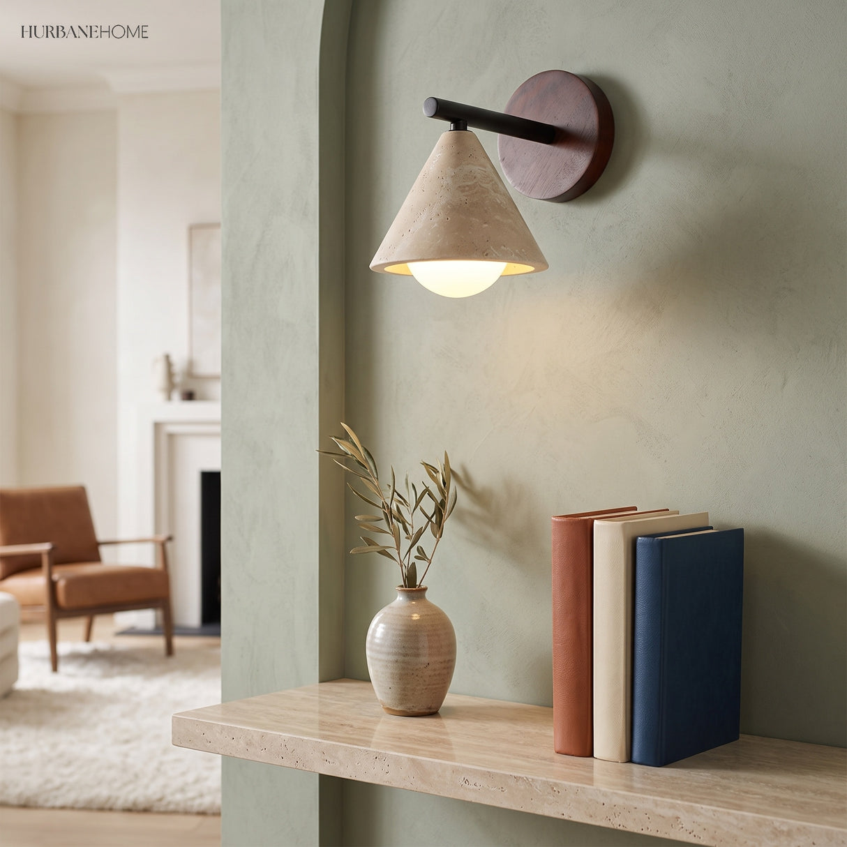Modern stone wall light above a shelf with books and a vase