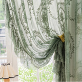 Sunlight filtering through floral embroidered sheer curtains, creating a soft, warm glow in the room.