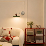 Chrome backplate and jointed arm detail on the wall mounted lamp