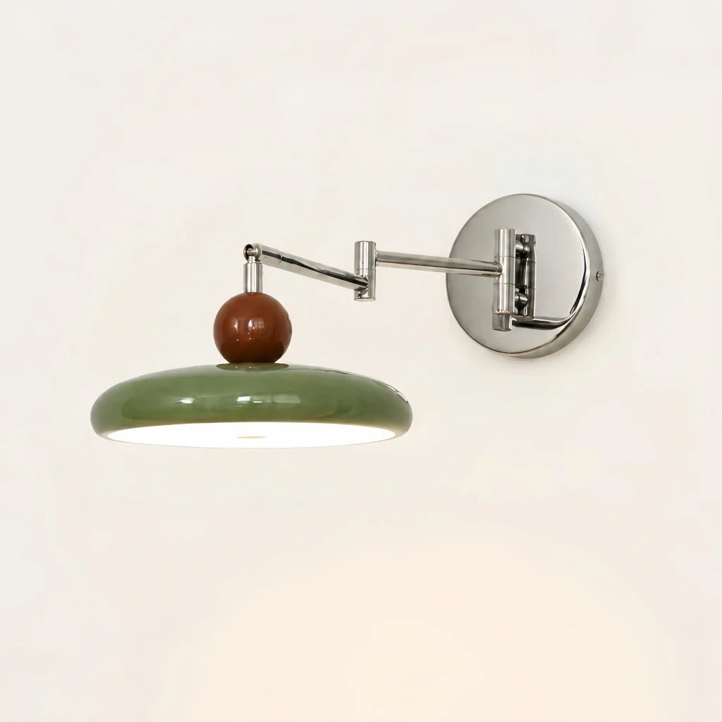 Front view of modern swing arm wall lamp with rounded disc shade