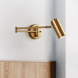 Gold swing arm sconce extended over a low wooden cabinet