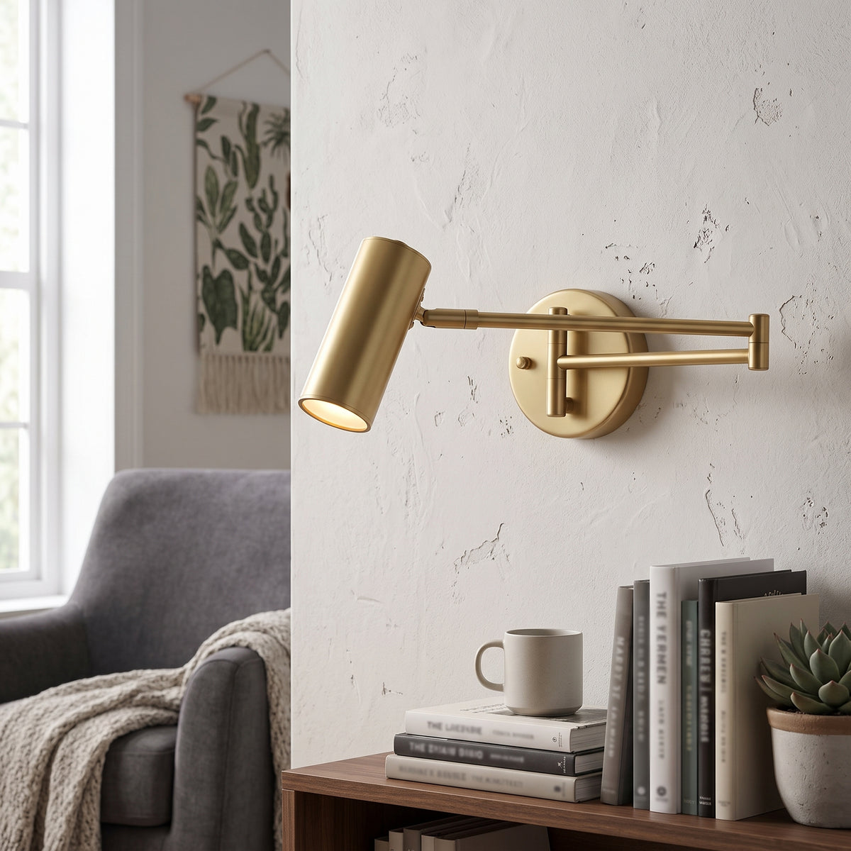 Gold swing arm wall sconce extended over a side table and books