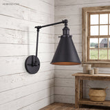 Black swing arm sconce on white shiplap above a rustic side table