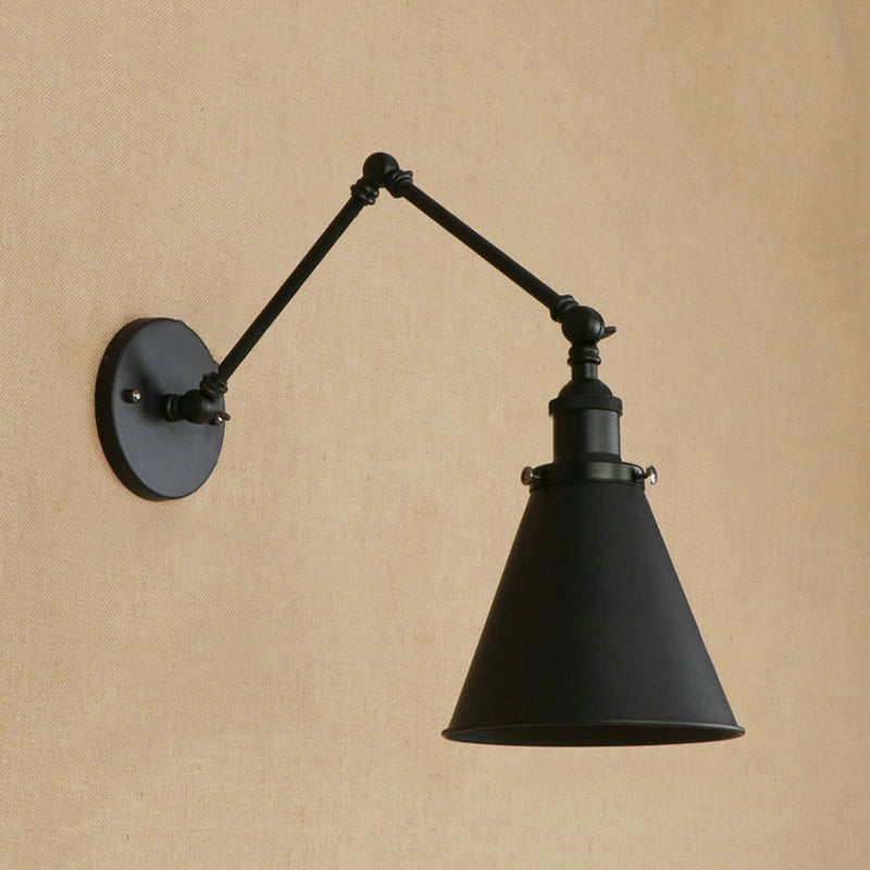 Black swing arm sconce with a cone shade on a warm tan wall