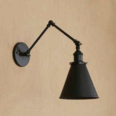 Black swing arm sconce with a cone shade on a warm tan wall