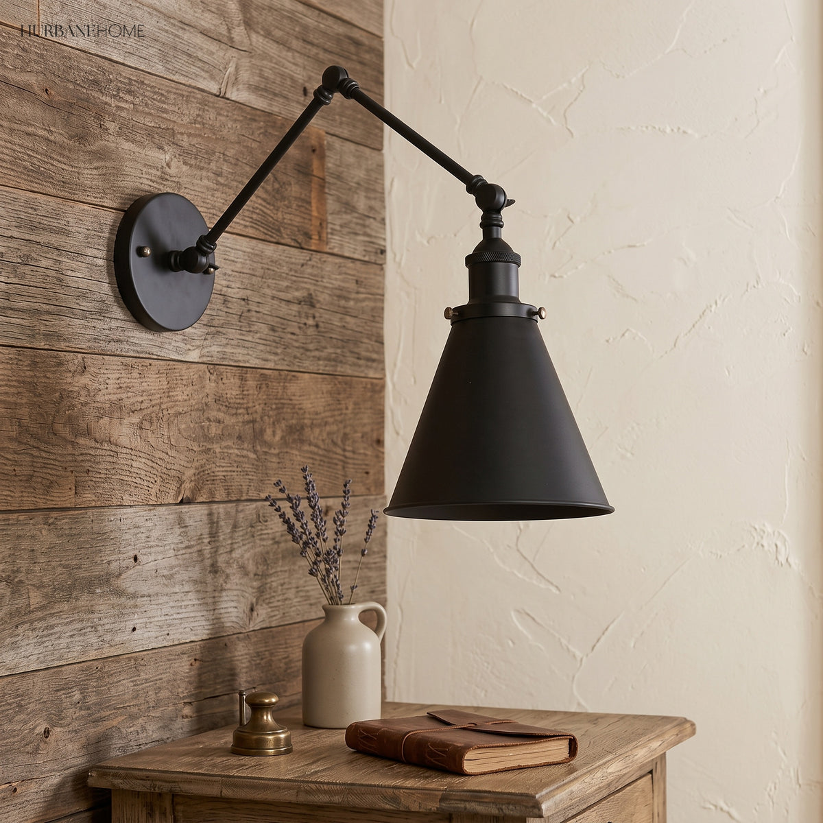 Black swing arm sconce on timber boards above a small writing desk