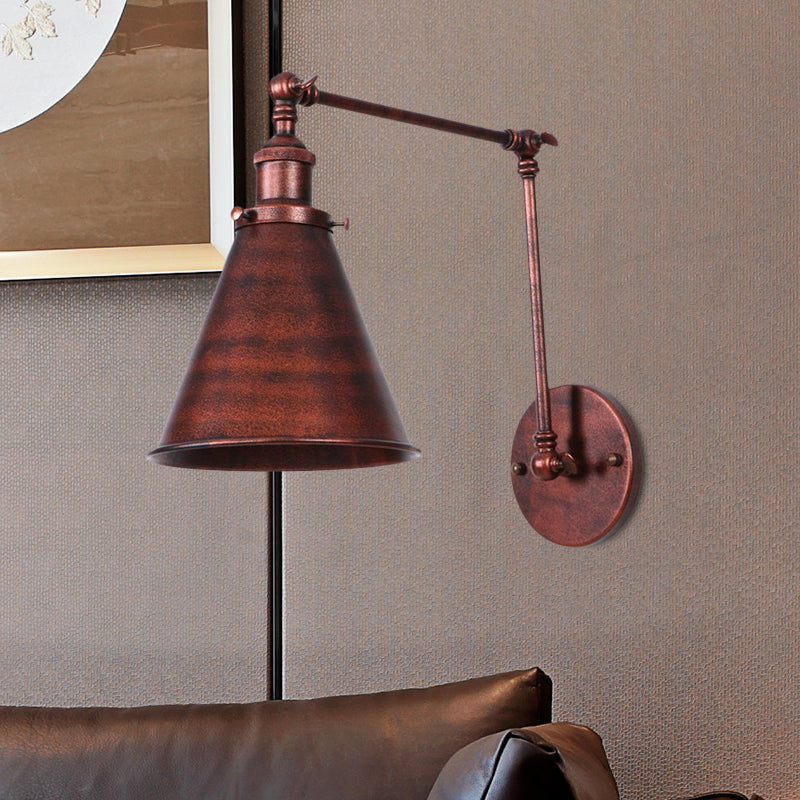 Rust swing arm sconce above a leather sofa beside framed art