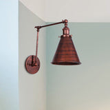 Rust swing arm sconce mounted in the corner of a pale blue room
