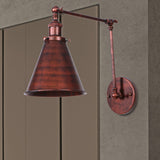Rust swing arm sconce cut out against a grey studio background