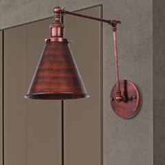 Rust swing arm sconce cut out against a grey studio background