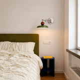 Side profile of adjustable swing arm wall sconce showing folding arm