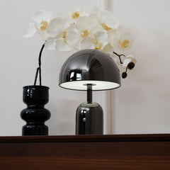 The dome shade raised to show the flat LED disc inside the lamp head