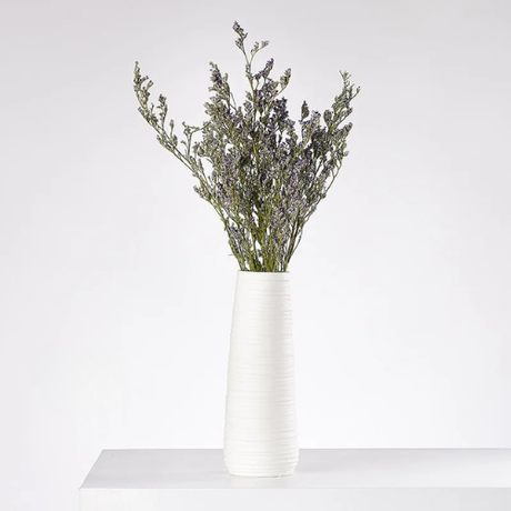 Textured ceramic vases arranged as sculptural shelf accents