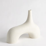 Sculptural cream décor displayed as textured stone vase on console table