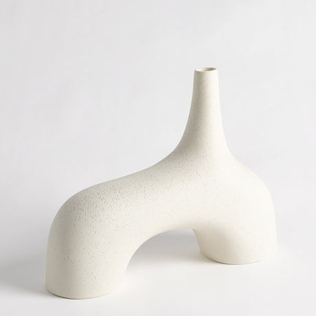 Sculptural cream décor displayed as textured stone vase on console table