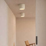 Textured cylinder ceiling light in a neutral colourway, close product view