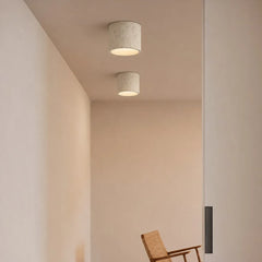 Textured cylinder ceiling light in a neutral colourway, close product view