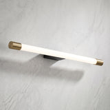 Slim aluminum tube LED wall sconce with brass end caps on a marble wall