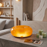 Amber donut glass lamp on a sideboard in a lounge
