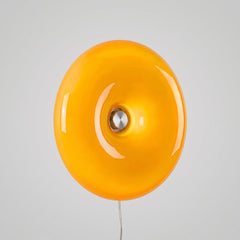 Amber donut-shaped round glass wall light