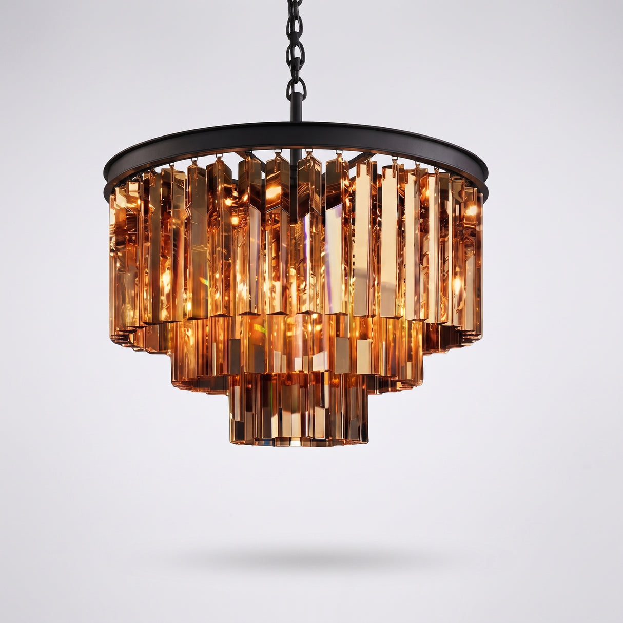 Amber tiered crystal chandelier with black metal frame on a plain studio background