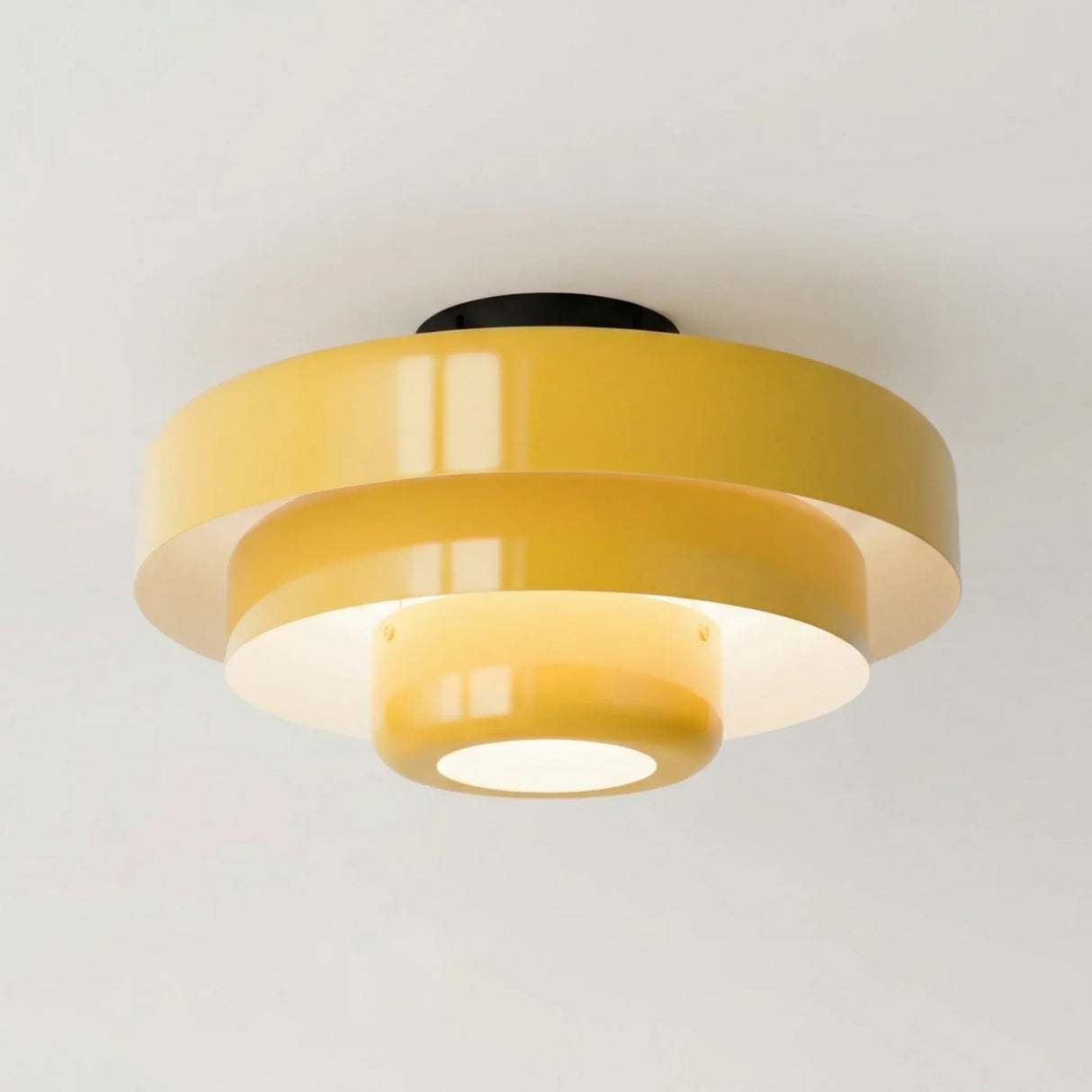 Brass tiered ceiling light with a warm metallic finish on white