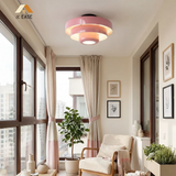 Orange tiered ceiling light viewed from below showing the lit diffuser
