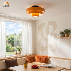 White tiered ceiling light shown flush against a white ceiling