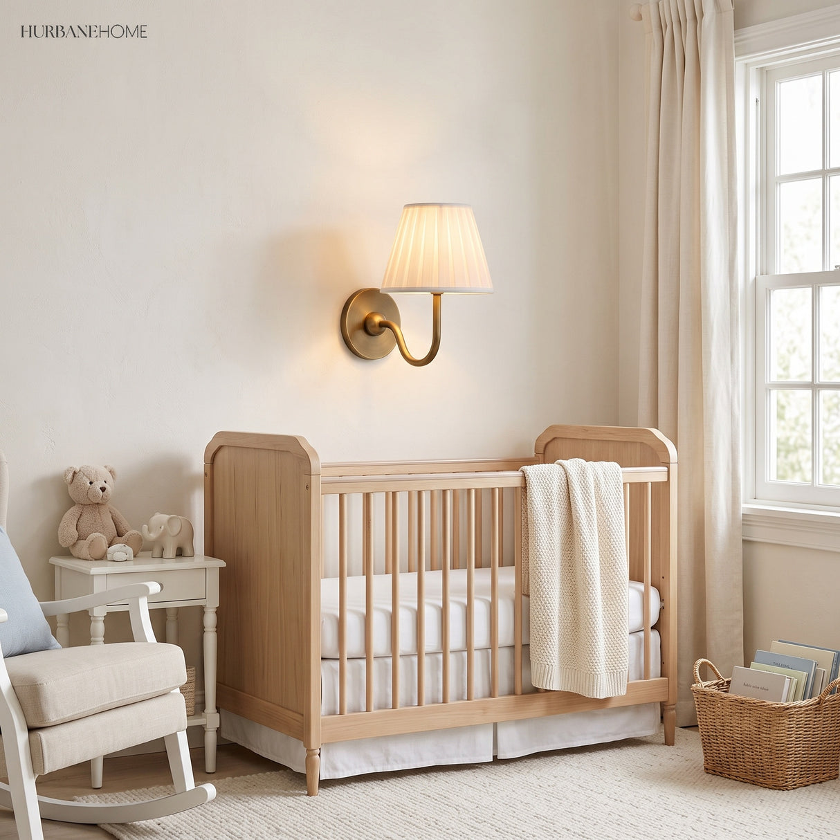 Brass finish pleated shade sconce lighting a nursery beside a wooden cot