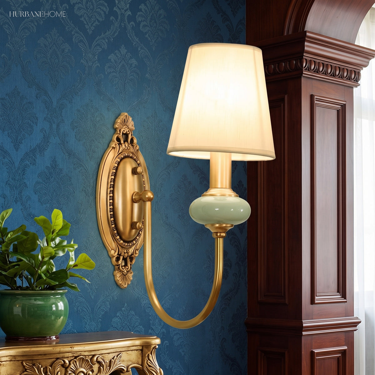 Single gold sconce with a white fabric shade on a deep blue wall