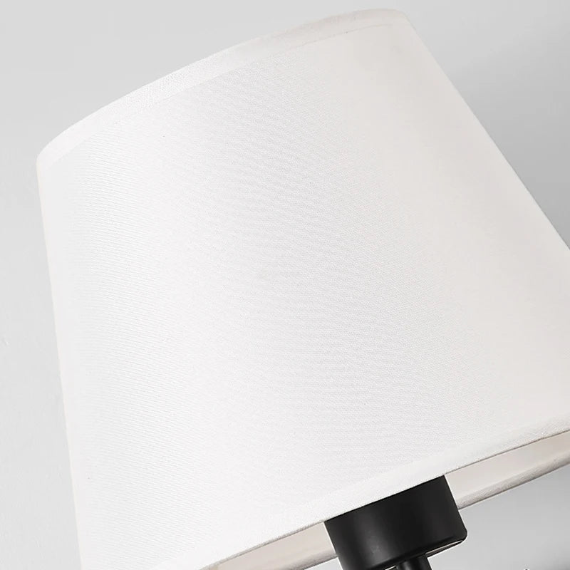 Close view of the woven white fabric shade and black lamp holder